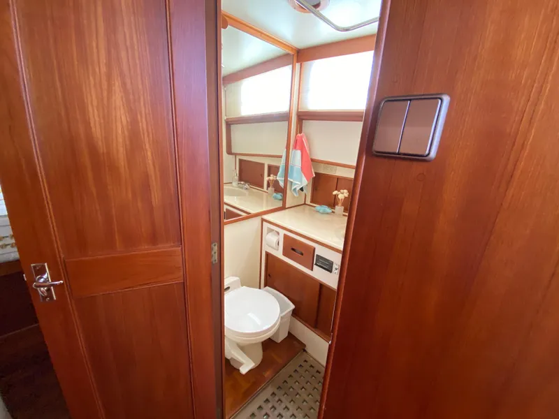 Slide: The Image of 1992 Grand Banks 46 Europa yacht bathroom with wooden cabinetry and modern fixtures. - 44