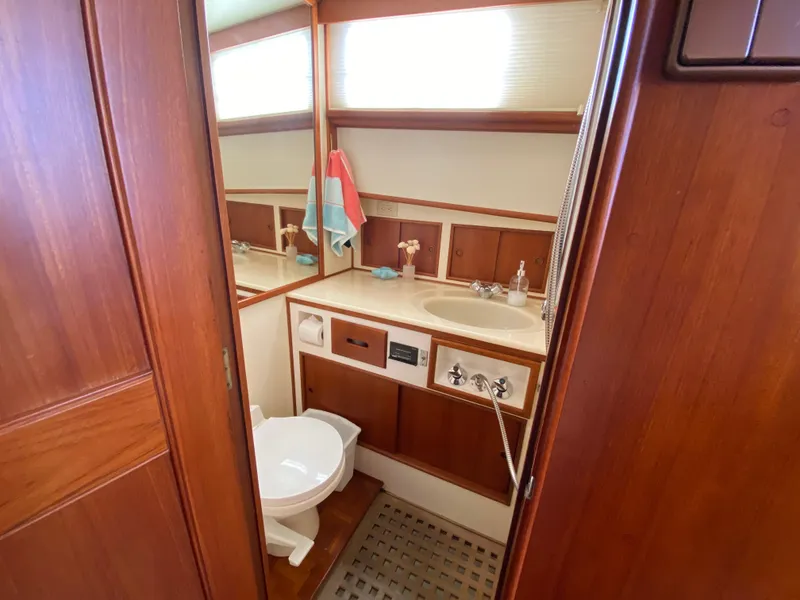 Slide: The Image of Bathroom interior of 1992 Grand Banks 46 Europa yacht, featuring wood paneling and modern fixtures. - 45