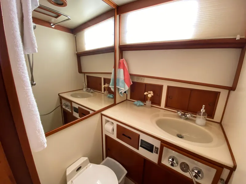 Slide: The Image of Bathroom interior of 1992 Grand Banks 46 Europa yacht, featuring dual sinks and wooden accents. - 47