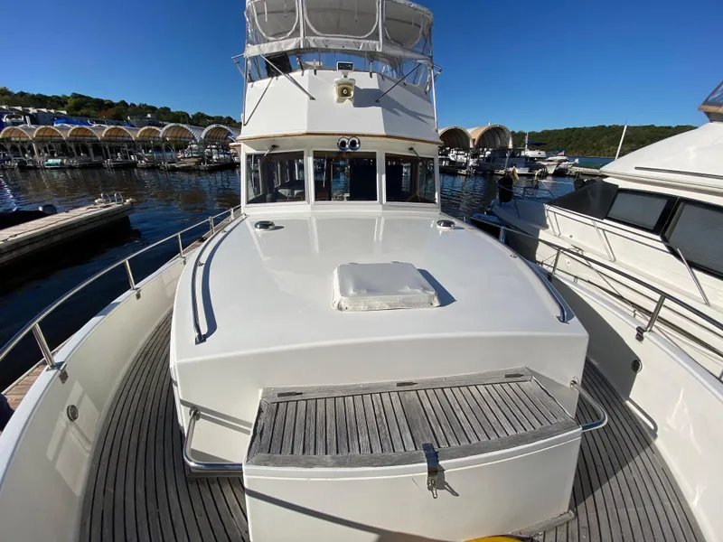 Slide: The Image of 1992 Grand Banks 46 Europa yacht docked at marina under clear blue sky. - 6