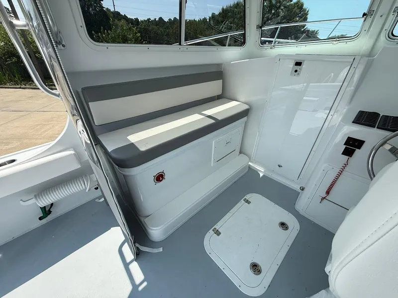 Slide: The Image of 2026 Steiger Craft 28 Fisherman interior with seating and storage compartments. - 10