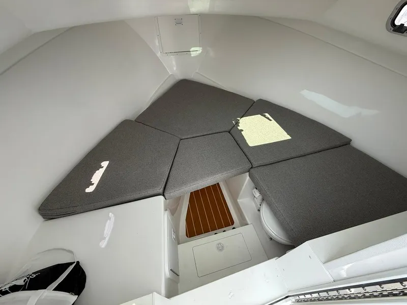 Slide: The Image of Interior cabin of 2026 Steiger Craft 28 Fisherman with cushioned seating and storage. - 15