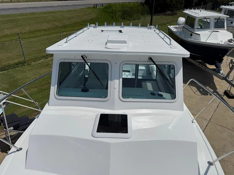 Slide: The Image of 2026 Steiger Craft 28 Fisherman boat, white exterior, docked on a sunny day. - 19