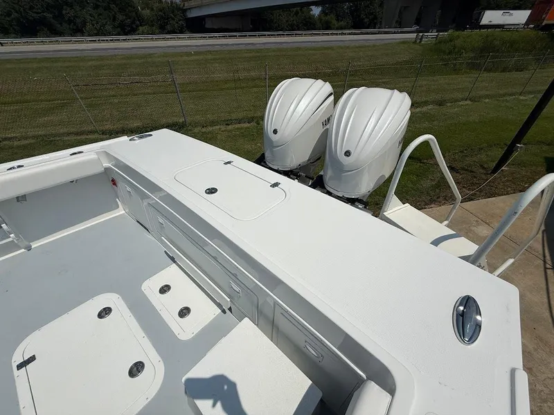 Slide: The Image of 2026 Steiger Craft 28 Fisherman boat with dual Yamaha outboard engines, docked near a highway. - 5