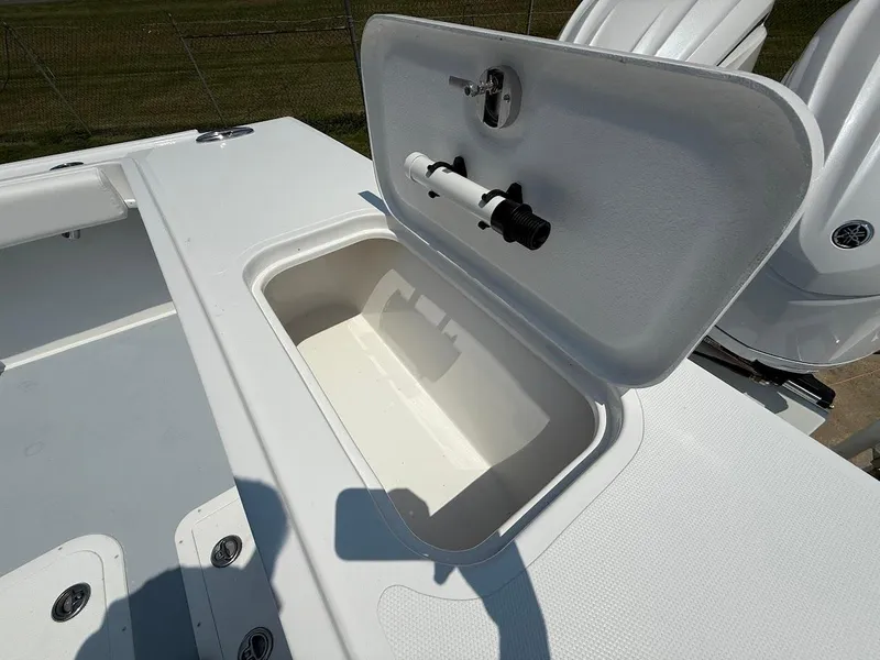 Slide: The Image of Open storage compartment on 2026 Steiger Craft 28 Fisherman boat deck. - 6