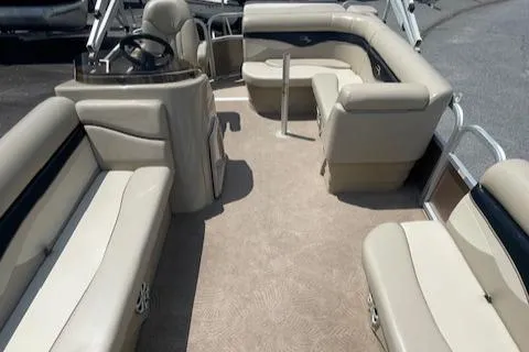 Slide: The Image of 2011 Bennington LSI boat interior with beige seating and steering console. - 10