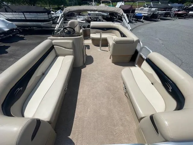 Slide: The Image of 2011 Bennington LSI pontoon boat with beige seating and spacious interior layout. - 3