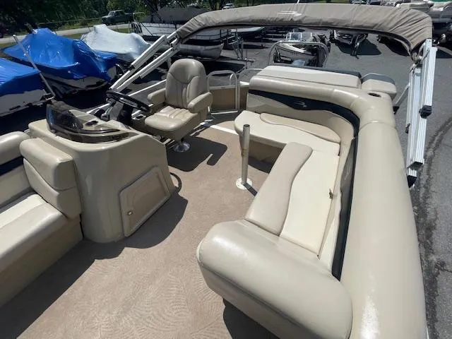 Slide: The Image of 2011 Bennington LSI pontoon boat with beige seating and canopy. - 4