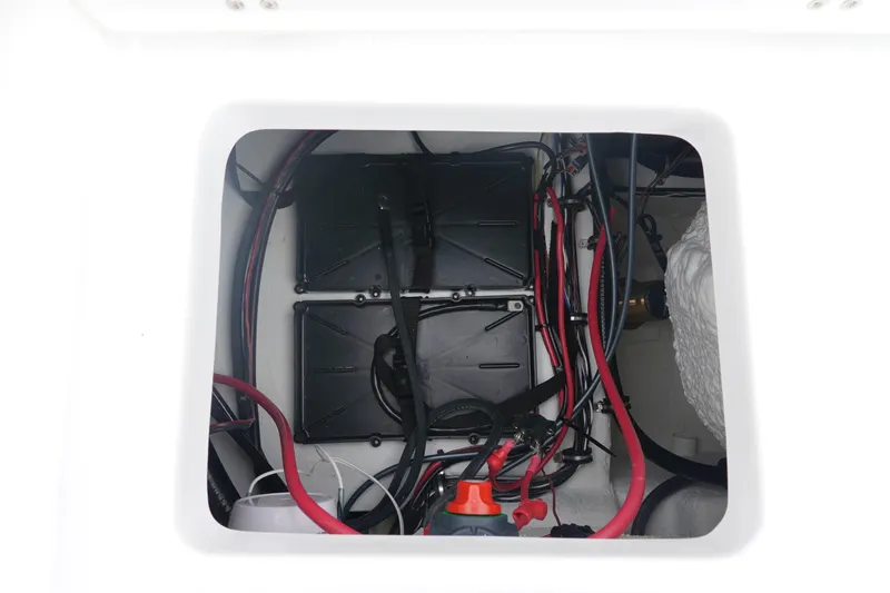 Slide: The Image of Battery compartment of 2026 Sea Hunt Ultra 229 boat with wiring and components. - 10