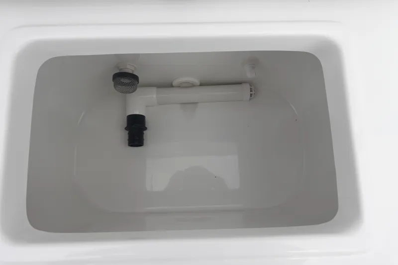 Slide: The Image of Livewell compartment in 2026 Sea Hunt Ultra 229 boat, featuring plumbing fixtures. - 11