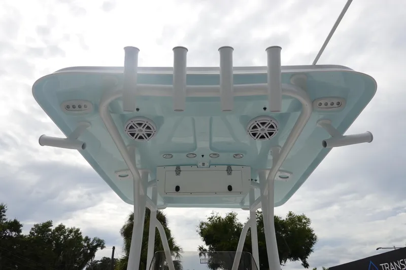 Slide: The Image of 2026 Sea Hunt Ultra 229 boat T-top with rod holders and speakers, viewed from below. - 14