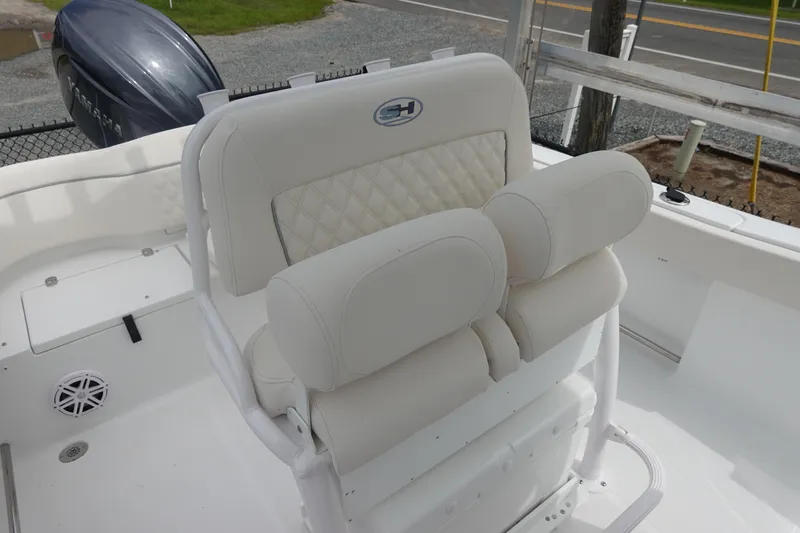 Slide: The Image of 2026 Sea Hunt Ultra 229 boat with white cushioned seating and Yamaha outboard motor. - 15