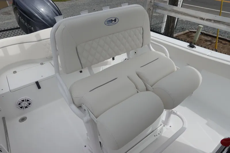 Slide: The Image of 2026 Sea Hunt Ultra 229 boat with white cushioned seating and Yamaha engine. - 16