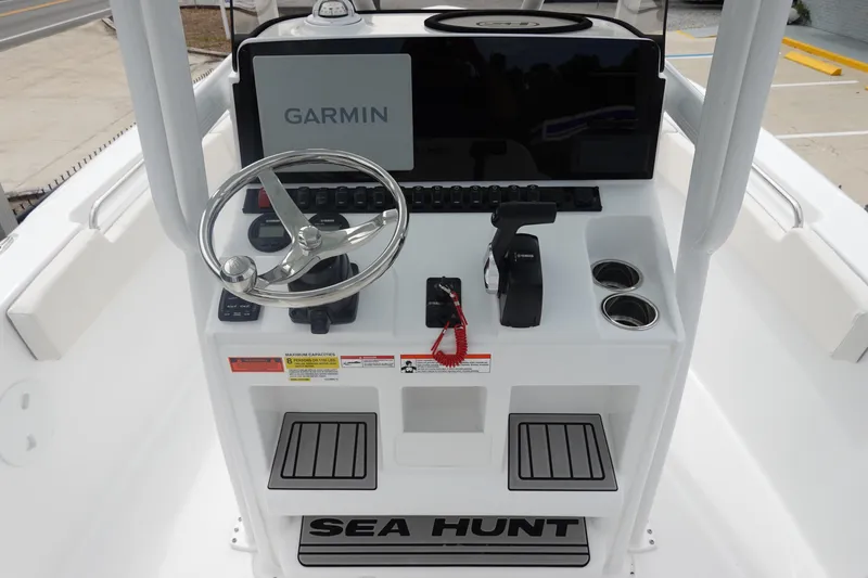 Slide: The Image of 2026 Sea Hunt Ultra 229 boat console with Garmin display and steering wheel. - 17