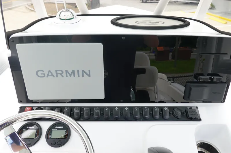 Slide: The Image of 2026 Sea Hunt Ultra 229 dashboard with Garmin navigation and Yamaha gauges. - 18