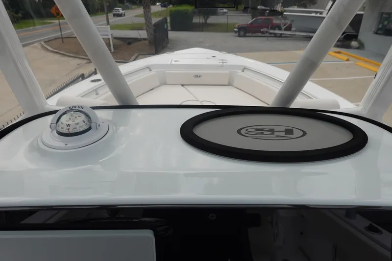 Slide: The Image of 2026 Sea Hunt Ultra 229 boat dashboard with compass and logo detail. - 19