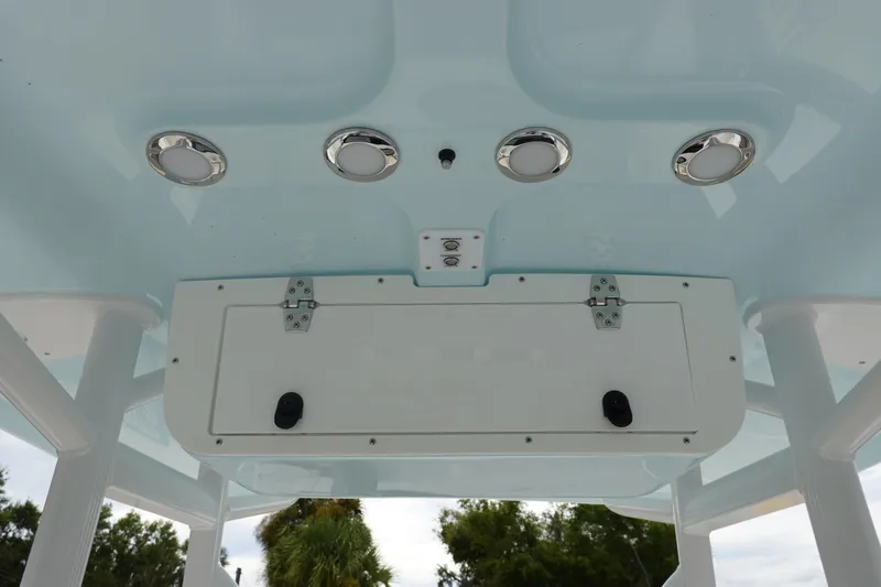 Slide: The Image of 2026 Sea Hunt Ultra 229 boat ceiling with lights and storage compartment. - 20