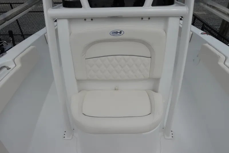 Slide: The Image of 2026 Sea Hunt Ultra 229 boat seat with white cushioned design. - 22