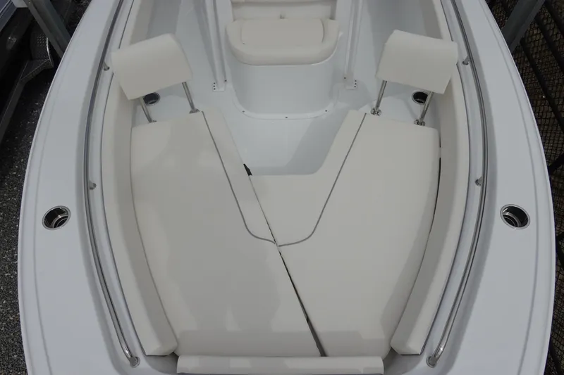 Slide: The Image of 2026 Sea Hunt Ultra 229 boat interior with cushioned seating and stainless steel railings. - 25