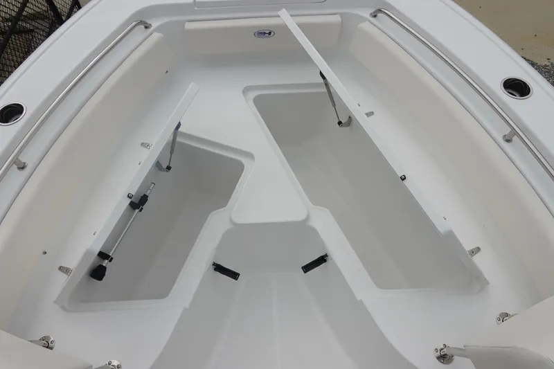 Slide: The Image of 2026 Sea Hunt Ultra 229 boat with open storage compartments and sleek design. - 27