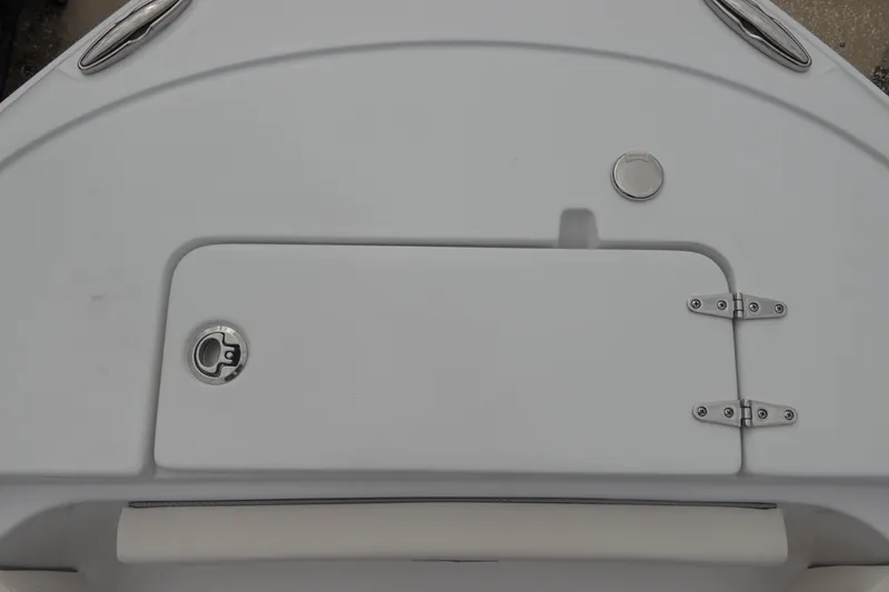 Slide: The Image of 2026 Sea Hunt Ultra 229 boat deck with storage compartment and stainless steel fittings. - 28