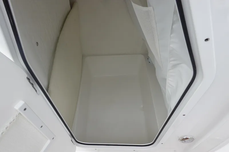 Slide: The Image of 2026 Sea Hunt Ultra 229 storage compartment interior, featuring white finish and spacious design. - 29
