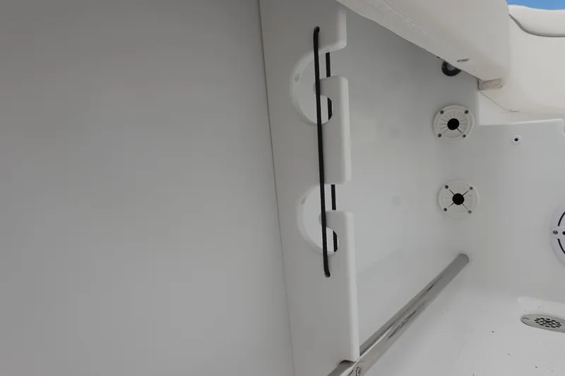 Slide: The Image of Interior view of 2026 Sea Hunt Ultra 229 boat, featuring rod holders and speakers. - 30