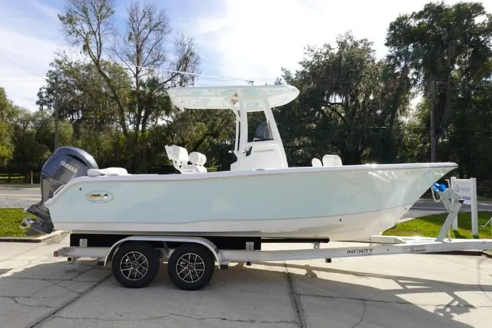Slide: The Image of 2026 Sea Hunt Ultra 229 boat on trailer, side view, outdoors. - 4