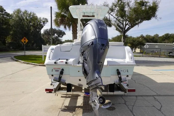 Slide: The Image of 2026 Sea Hunt Ultra 229 boat with Yamaha 200 engine, parked outdoors. - 5