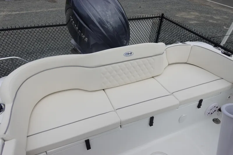 Slide: The Image of 2026 Sea Hunt Ultra 229 boat with white cushioned seating and Yamaha outboard motor. - 7
