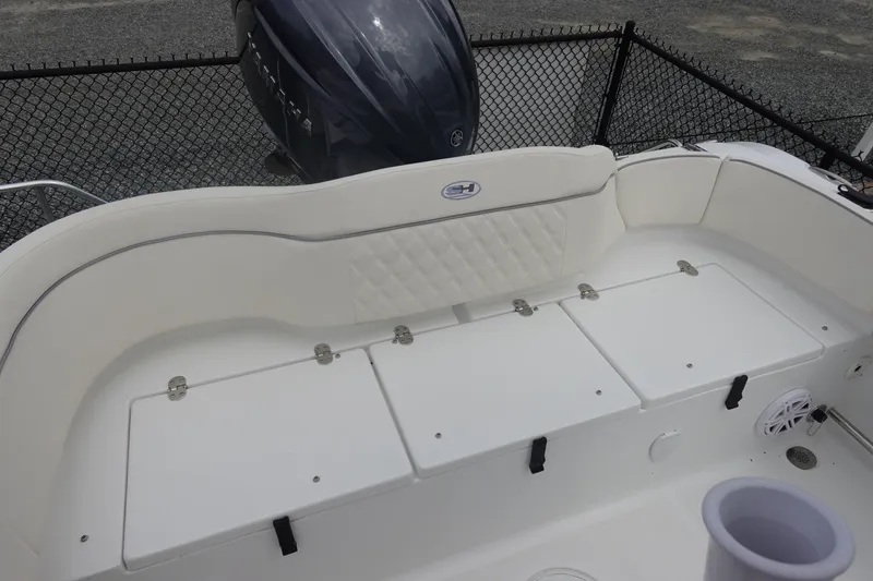 Slide: The Image of 2026 Sea Hunt Ultra 229 boat interior with cushioned seating and storage compartments. - 8
