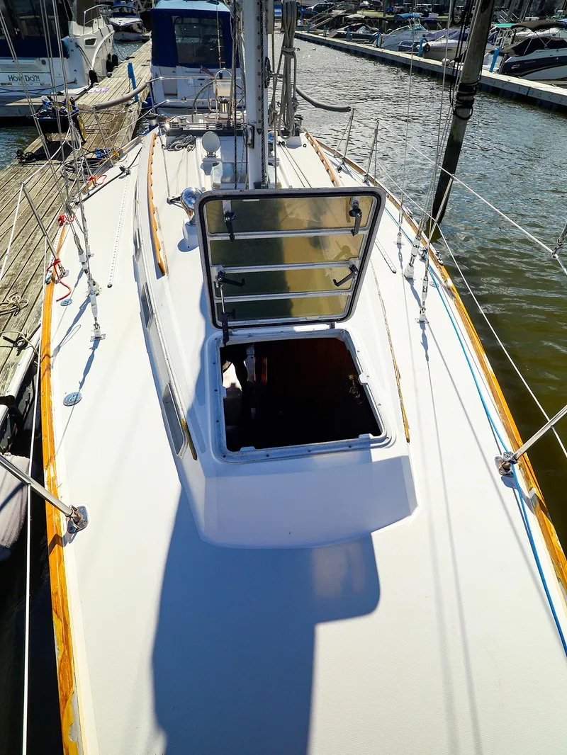 Slide: The Image of 1987 Sabre 36 Sloop sailboat with open hatch, docked at marina. - 10