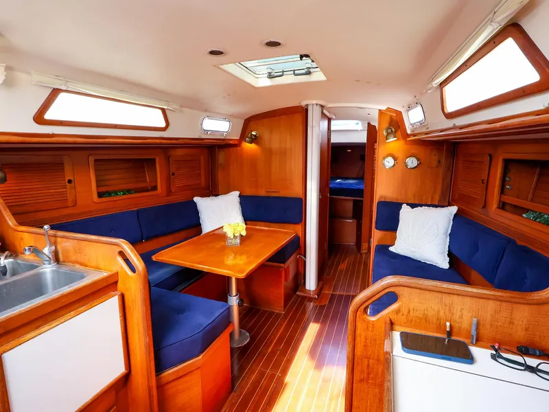 Slide: The Image of Interior of 1987 Sabre 36 Sloop yacht with wooden finish and blue seating. - 18
