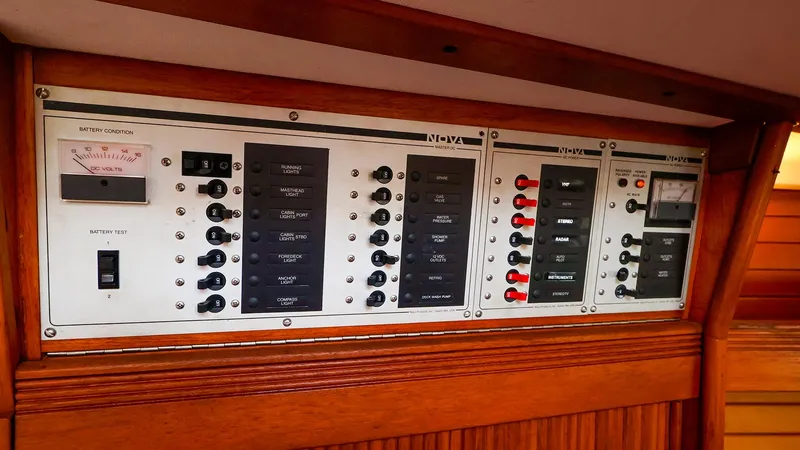 Slide: The Image of Electrical control panel on a 1987 Sabre 36 Sloop sailboat, featuring various switches and gauges. - 24