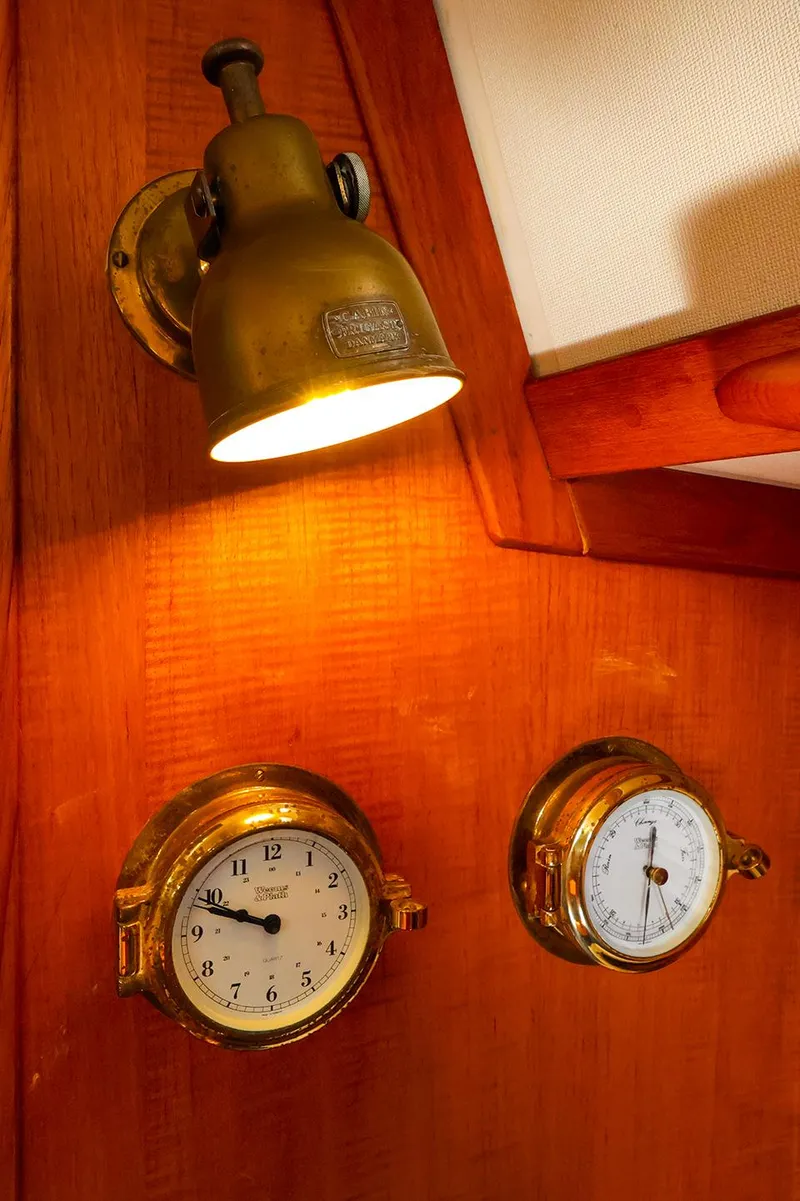 Slide: The Image of Vintage brass clock and barometer under a lamp on a 1987 Sabre 36 Sloop yacht. - 25