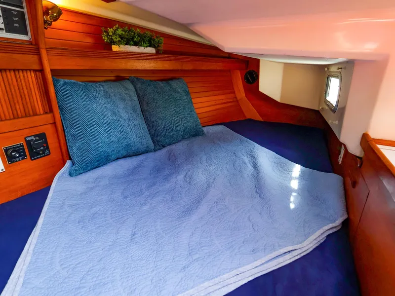 Slide: The Image of Cozy cabin interior of 1987 Sabre 36 Sloop with blue bedding and wooden accents. - 29