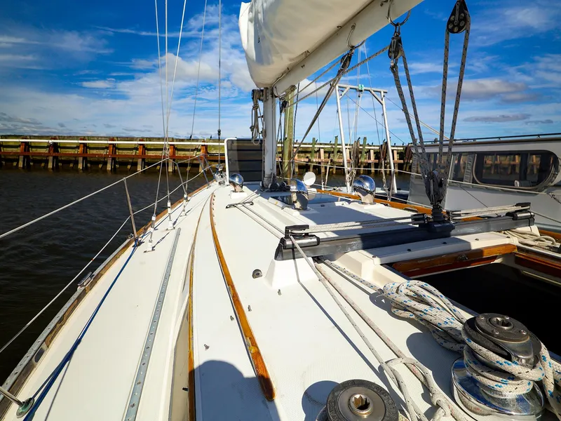 Slide: The Image of 1987 Sabre 36 Sloop sailboat deck with rigging, under a clear blue sky. - 7