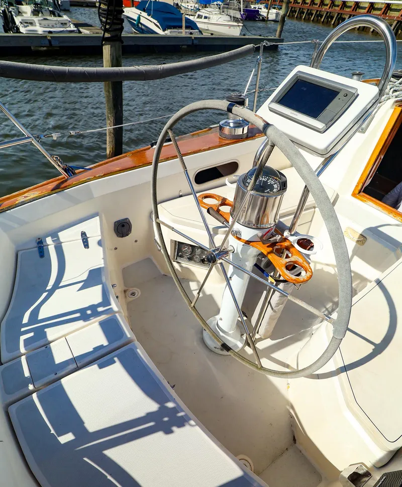 Slide: The Image of Cockpit of 1987 Sabre 36 Sloop with steering wheel and navigation equipment. - 12