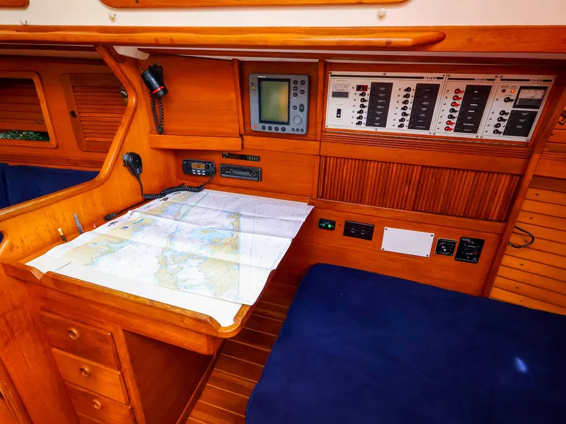 Slide: The Image of Navigation station of a 1987 Sabre 36 Sloop with chart and control panels. - 21