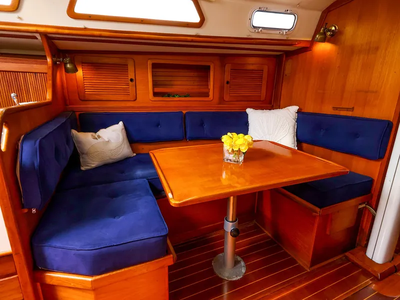Slide: The Image of Cozy interior of 1987 Sabre 36 Sloop with blue cushions and wooden table. - 27