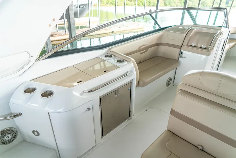 Slide: The Image of 2012 Formula 310 Bowrider interior with seating and storage, featuring sleek design and cup holders. - 12