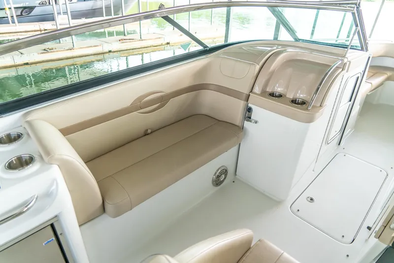 Slide: The Image of 2012 Formula 310 Bowrider interior with beige seating and cup holders. - 14