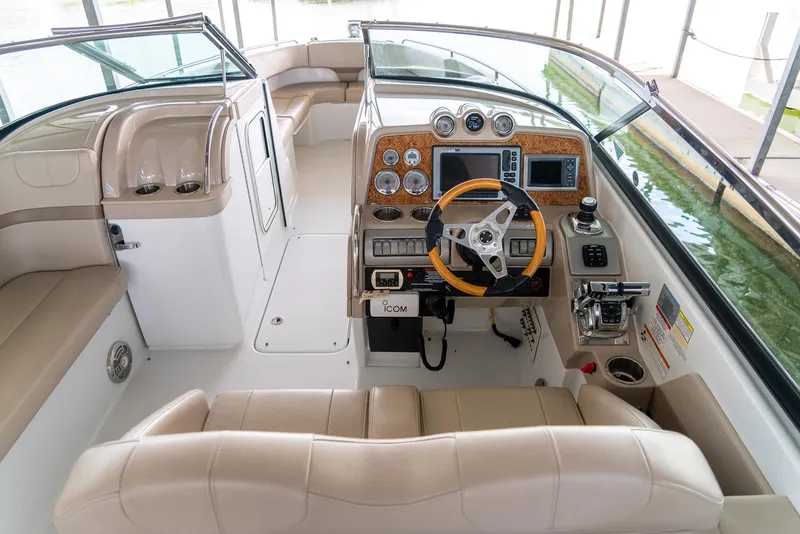 Slide: The Image of 2012 Formula 310 Bowrider cockpit with modern controls and beige seating. - 17