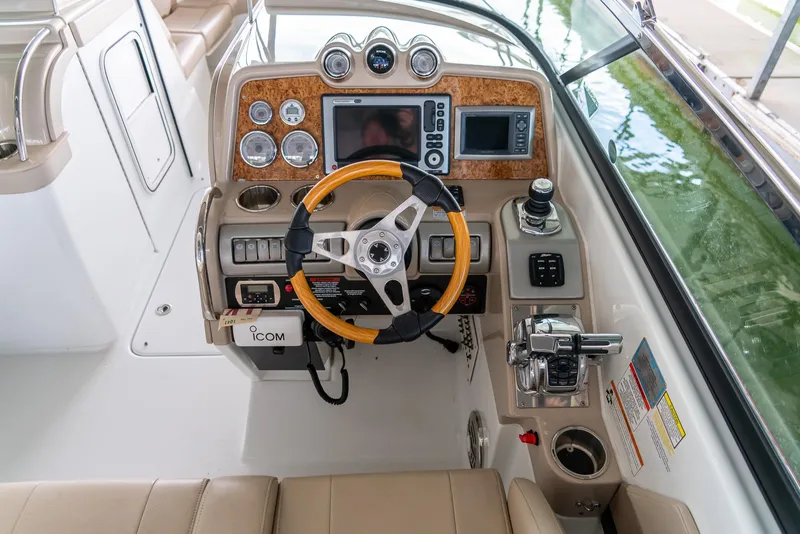 Slide: The Image of 2012 Formula 310 Bowrider helm with wood accents and modern navigation controls. - 18