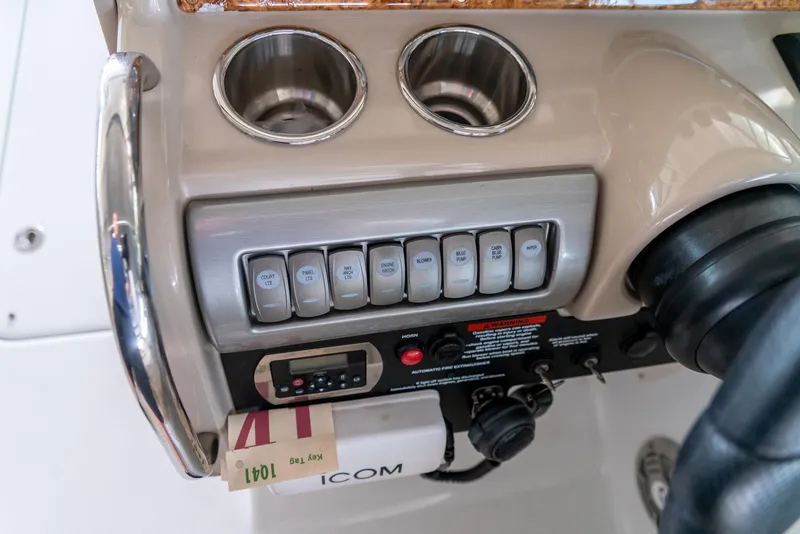 Slide: The Image of Control panel of a 2012 Formula 310 Bowrider boat with switches and cup holders. - 20