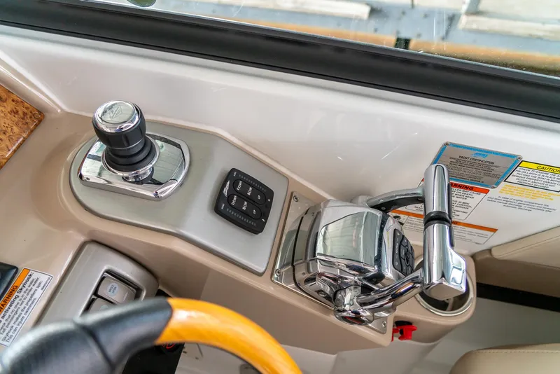 Slide: The Image of 2012 Formula 310 Bowrider helm controls with joystick and throttle levers. - 22