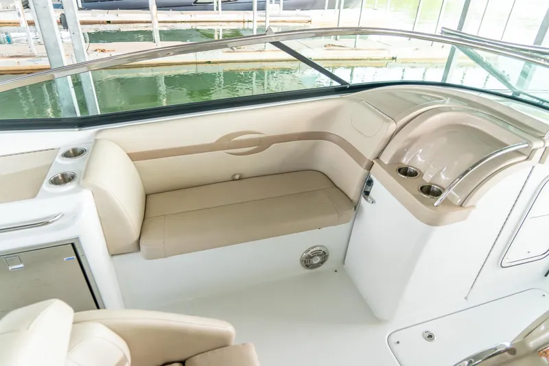 Slide: The Image of 2012 Formula 310 Bowrider interior with beige seating and cup holders. - 24