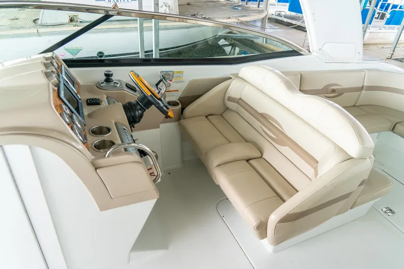 Slide: The Image of 2012 Formula 310 Bowrider cockpit with beige seating and modern controls. - 26