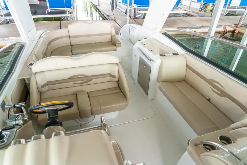 Slide: The Image of 2012 Formula 310 Bowrider interior with beige seating and steering wheel. - 27