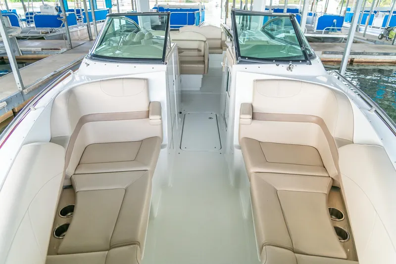 Slide: The Image of 2012 Formula 310 Bowrider interior with beige seating and cup holders. - 29
